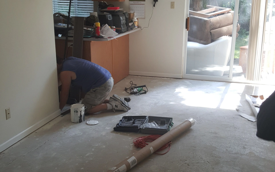 worker applying some tiles on a flooring